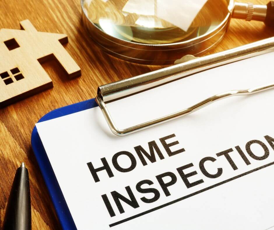 This image features a magnifying glass and The Ultimate Guide to Home Inspections